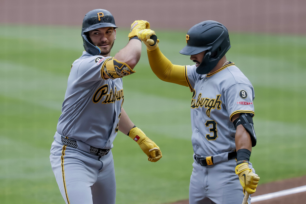 Pittsburgh Pirates' Spencer Horwitz, left, is greeted by Nick Gonzales, right, after hitting a leadoff home run against the Atlanta Braves during the first inning of a baseball game, Sunday, June 7, 2026, in Atlanta. (AP Photo/Erik S. Lesser)