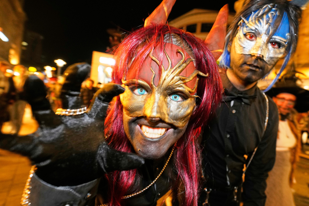 People dressed up in scary costumes take part in a Halloween Zombie protest walk at the city center of Essen, Germany, Friday, Oct. 31, 2025. (AP Photo/Martin Meissner)