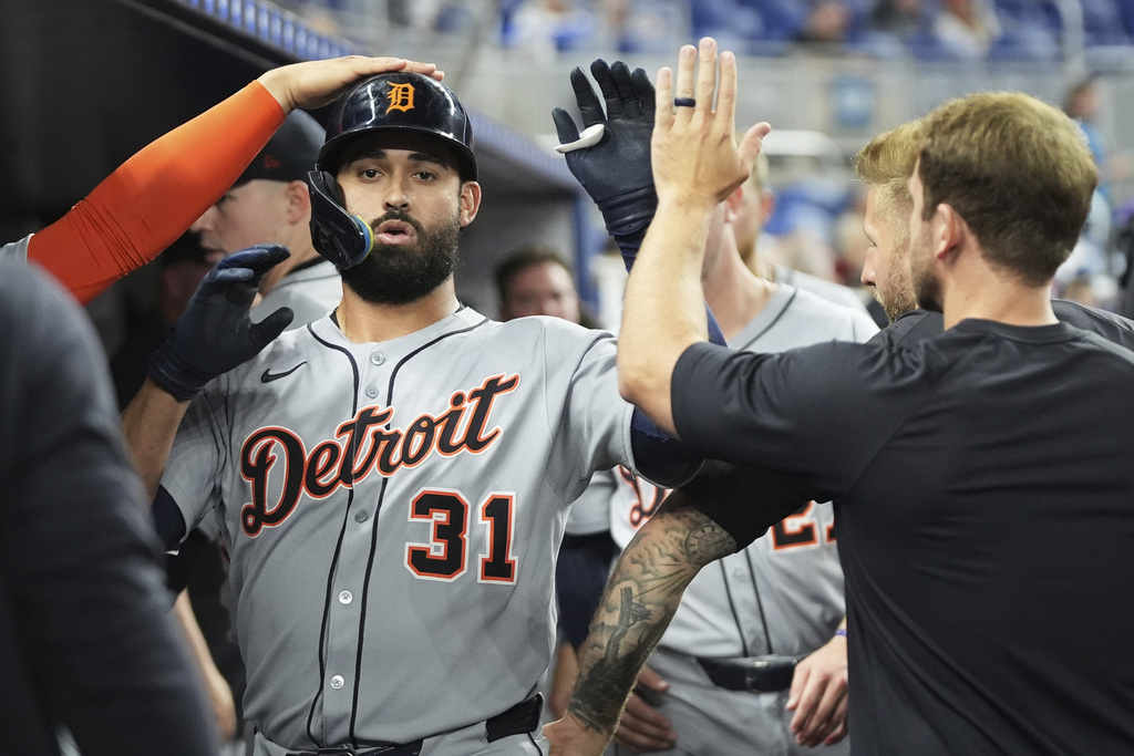 Detroit Tigers' Riley Greene (31) is congratulated in the dugout after hitting a solo home run during the fourth inning of a baseball game against the Miami Marlins, Friday, Sept. 12, 2025, in Miami. (AP Photo/Lynne Sladky)