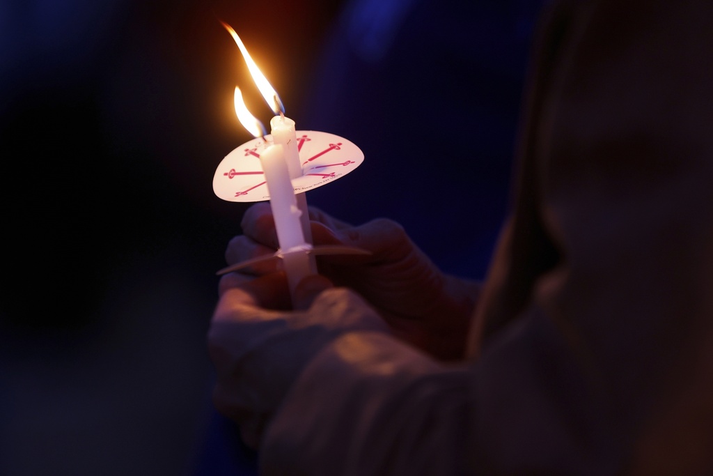 People gather at a vigil at Lynnhurst Park after a shooting at the Annunciation Catholic School Wednesday, Aug. 27, 2025, in Minneapolis. (AP Photo/Bruce Kluckhohn)