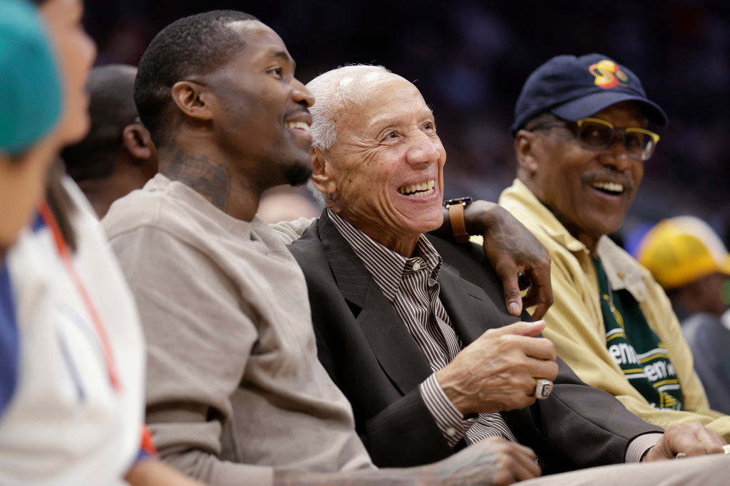 FILE - Retired NBA player Jamal Crawford, left, and former player Lenny Wilkens smile as they sit court side during a preseason basketball game between the LA Clippers and the Portland Trail Blazers, Oct. 3, 2022, in Seattle. (AP Photo/John Froschauer, File)