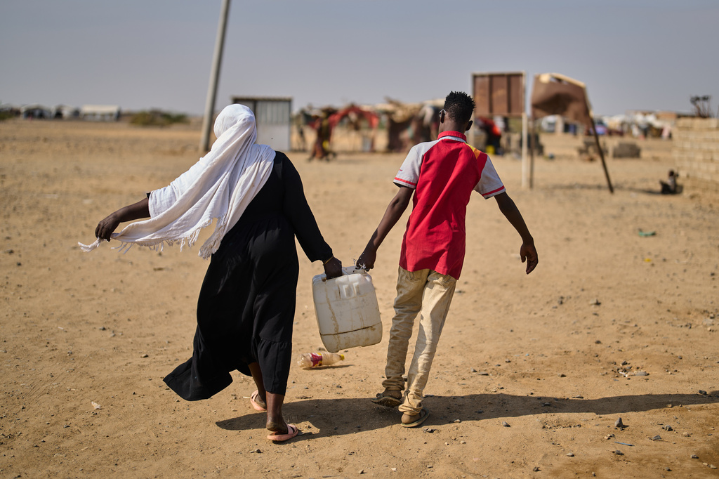 Internally displaced Sudanese people haul water in a container at the Al Heshan camp in Port Sudan, Sudan, Wednesday, April 15, 2026. (AP Photo/Bernat Armangue)
