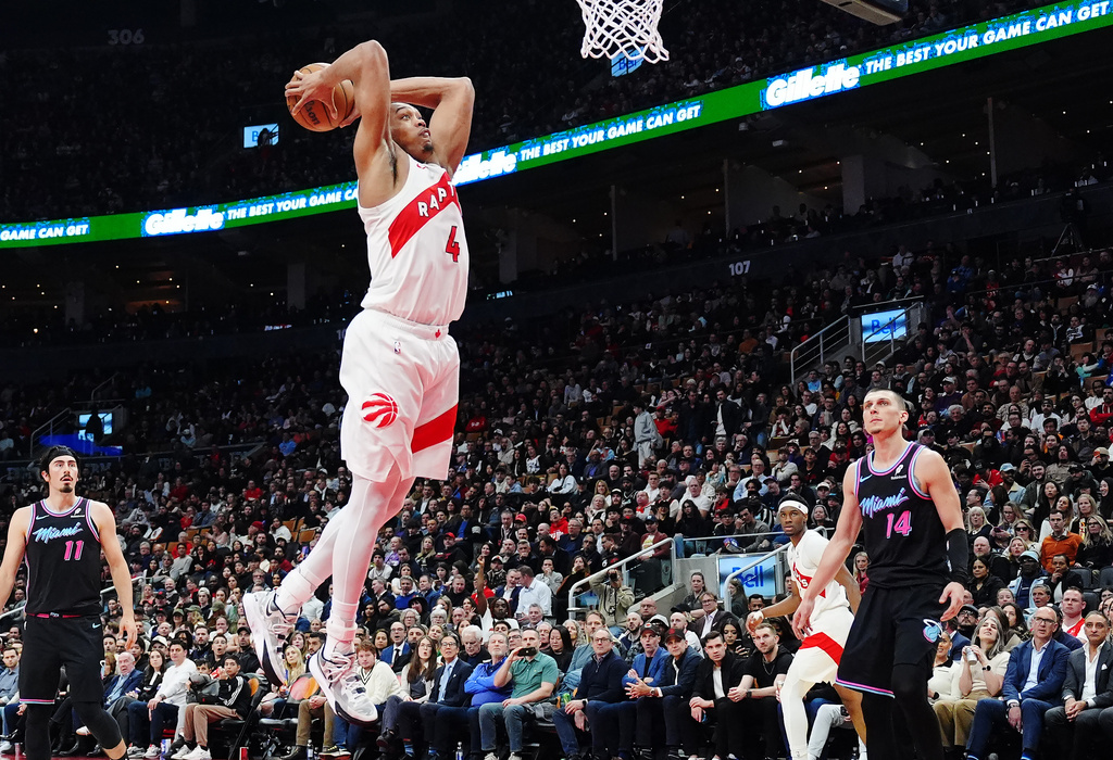 Toronto Raptors' Scottie Barnes (4) dunks against the Miami Heat during the first half of an NBA basketball game in Toronto, Tuesday, April 7, 2026. (Frank Gunn/The Canadian Press via AP)