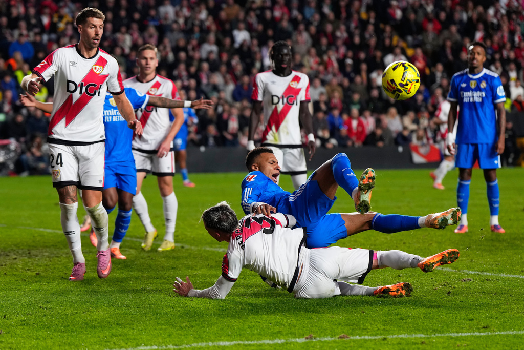 Real Madrid's Kylian Mbappe collides with Rayo's Pep Chavarria in an attempt to score during a Spanish La Liga soccer match between Rayo Vallecano and Real Madrid in Madrid, Spain, Sunday, Nov. 9, 2025. (AP Photo/Manu Fernandez)