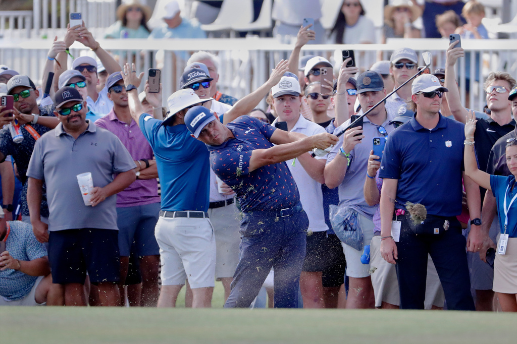 Gary Woodland hits on the 18th fairway next to the gallery during the final round of the Texas Children's Houston Open golf tournament Sunday, March 29, 2026, in Houston. (AP Photo/Michael Wyke)