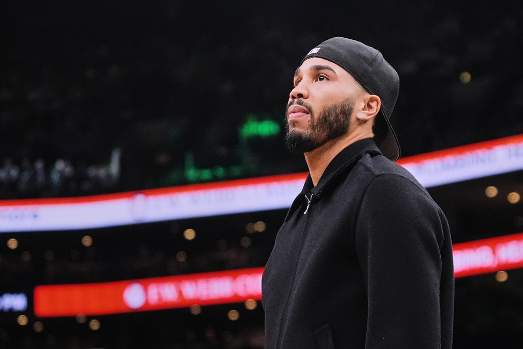 Boston Celtics forward Jayson Tatum, who is out with an injury, stands near the bench during a time out in the first half of an NBA basketball game against the Denver Nuggets, Wednesday, Jan. 7, 2026, in Boston. (AP Photo/Charles Krupa)