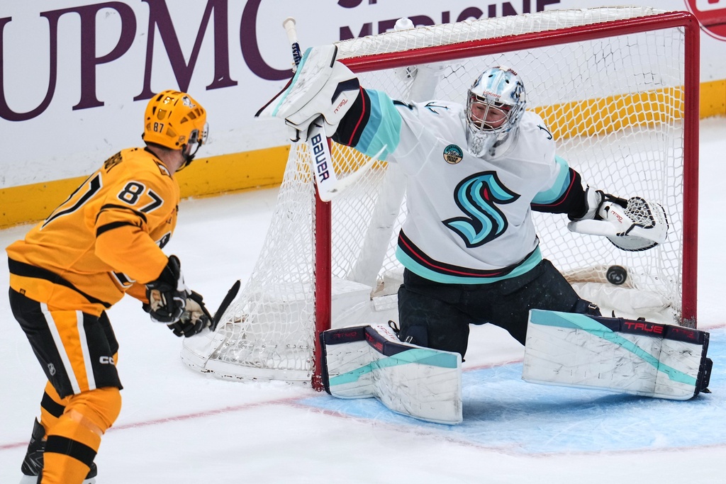 Seattle Kraken goaltender Philipp Grubauer (31) blocks a shot by Pittsburgh Penguins' Sidney Crosby (87) during the first period of an NHL hockey game in Pittsburgh, Saturday, Nov. 22, 2025. (AP Photo/Gene J. Puskar)