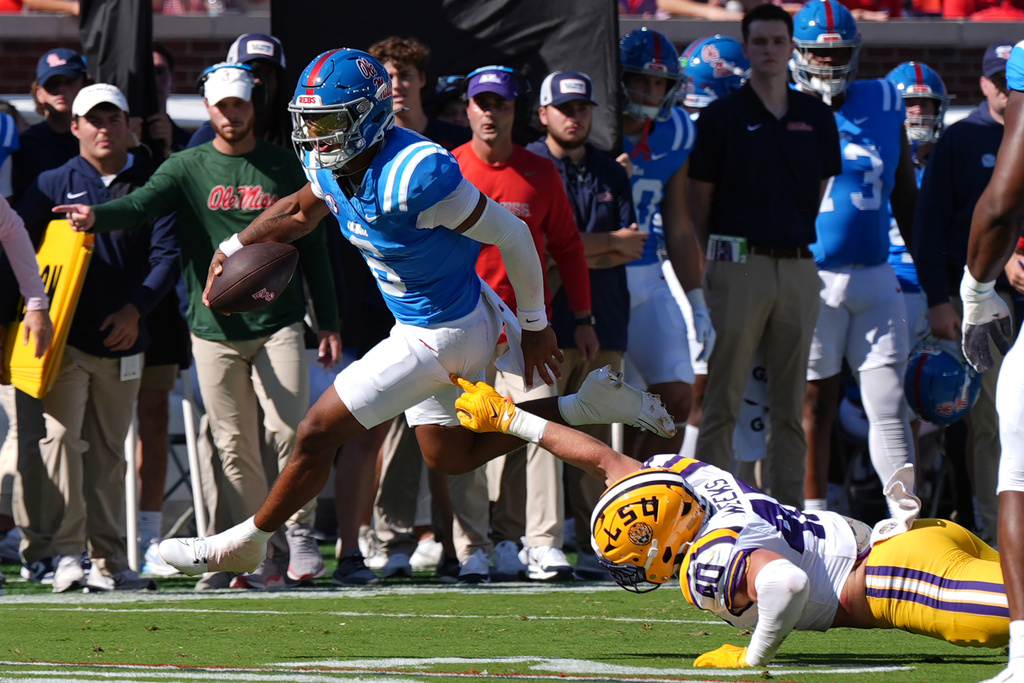 Mississippi quarterback Trinidad Chambliss (6) evades a tackle attempt by LSU linebacker Whit Weeks (40) during the first half of an NCAA college football game in Oxford, Miss., Saturday, Sept. 27, 2025. (AP Photo/Rogelio V. Solis)