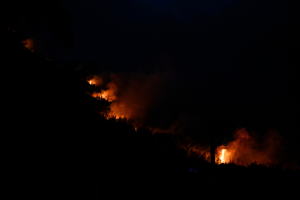 Flames are seen on a mountainside during a wildfire near Porto Germeno, northwest of Athens, Greece, Sunday, Aug. 2, 2026. (AP Photo/Michael Varaklas)