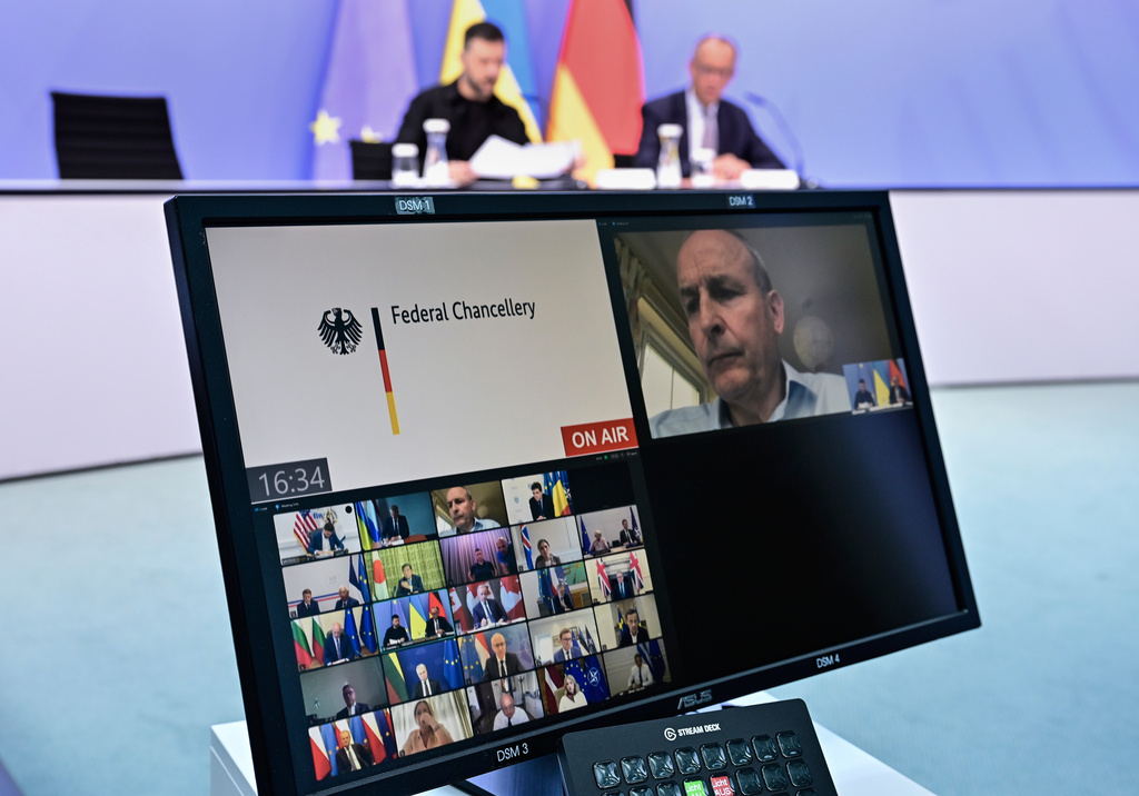 Ukrainian President Volodymyr Zelenskyy, left, and German Chancellor Friedrich Merz attend a video meeting of European leaders with US President Donald Trump on the Ukraine war in Berlin, Germany, Wednesday, Aug. 13, 2025, ahead of the summit between the US and Russian leaders. (John MacDougall/Pool Photo via AP)