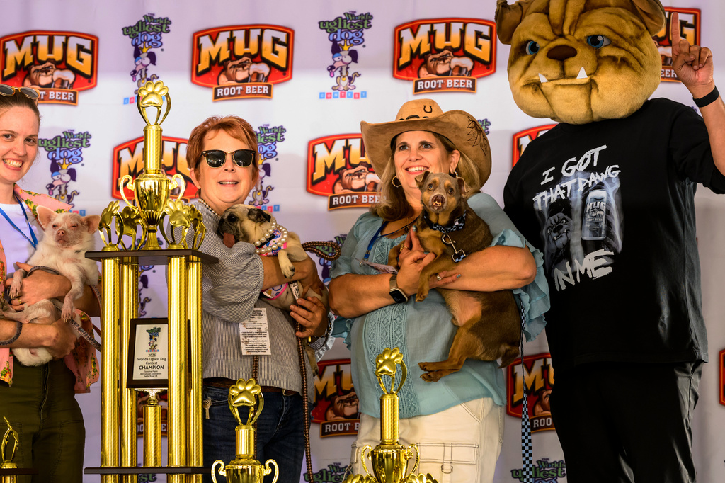 Winners stand with their trophies during the World's Ugliest Dog Contest at the Sonoma County Fair in Santa Rosa, Calif., on Friday, Aug. 14, 2026. (AP Photo/Noah Berger)