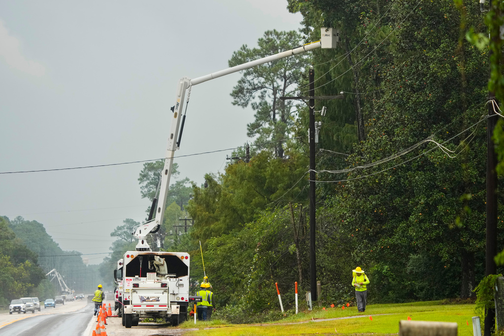 Crews trip vegetation off power lines in the aftermath of Tropical Storm Edouard east of Cleveland, Texas, Wednesday, Sept. 2, 2026. (Brett Coomer/Houston Chronicle via AP)