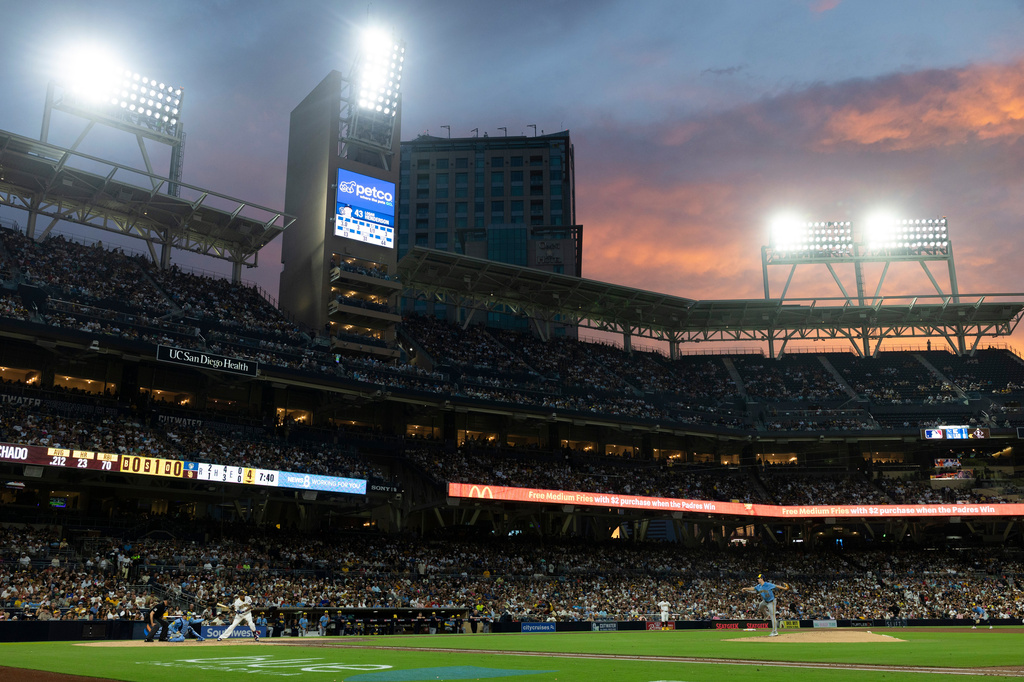 Milwaukee Brewers starting pitcher Logan Henderson, right, works against San Diego Padres' Manny Machado, third from left, in the fourth inning of a baseball game Monday, Aug. 10, 2026, in San Diego. (AP Photo/Karl Anderson)