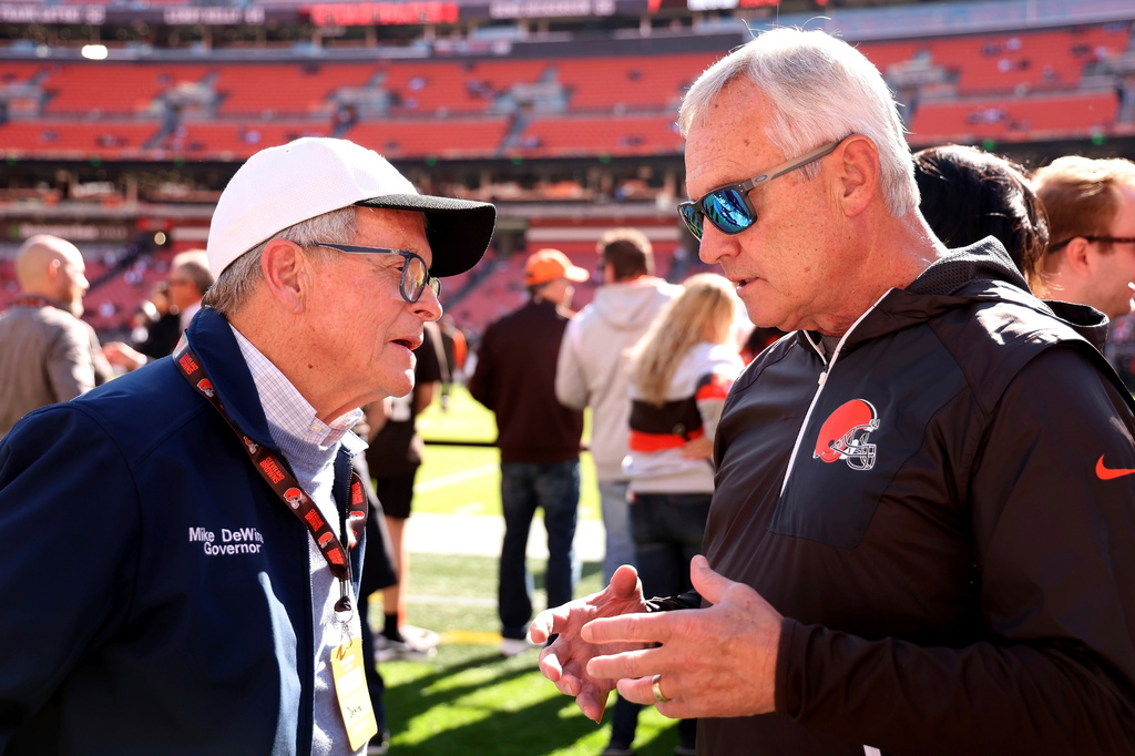 FILE - Ohio Gov. Mike DeWine talks with former Ohio State coach Jim Tressel while standing on the sideline prior to the start of an NFL football game between the Cincinnati Bengals and the Cleveland Browns, Oct. 20, 2024, in Cleveland. (AP Photo/Kirk Irwin, File)