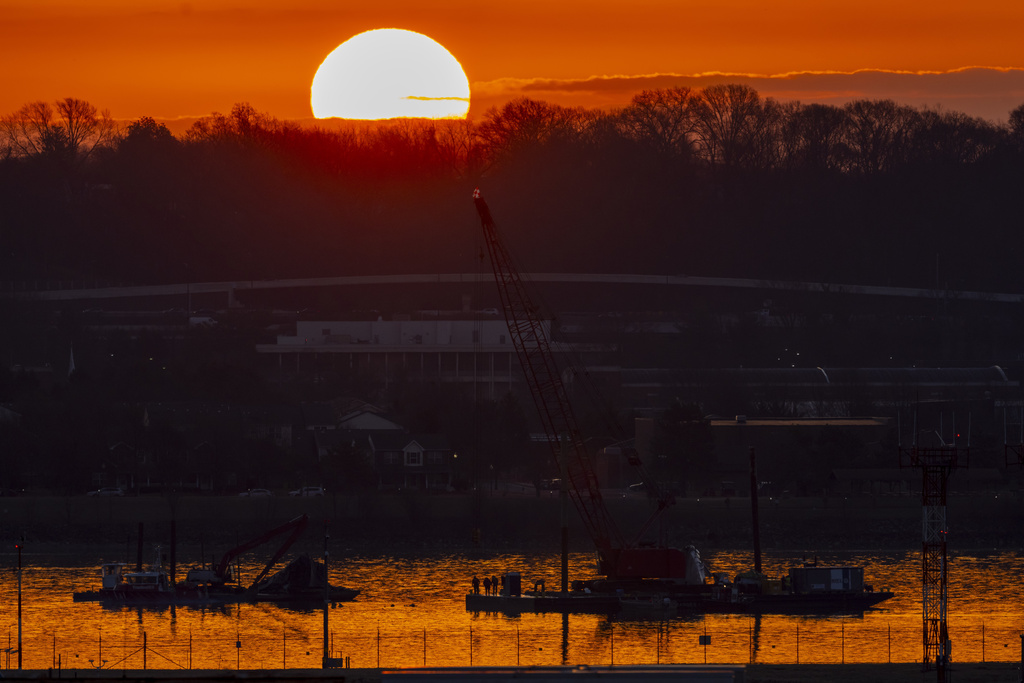 FILE - Salvage crews work near the wreckage site in the Potomac River of a mid-air collision between an American Airlines jet and a Black Hawk helicopter, at Ronald Reagan Washington National Airport, Feb. 4, 2025, in Arlington, Va. (AP Photo/Ben Curtis, file)