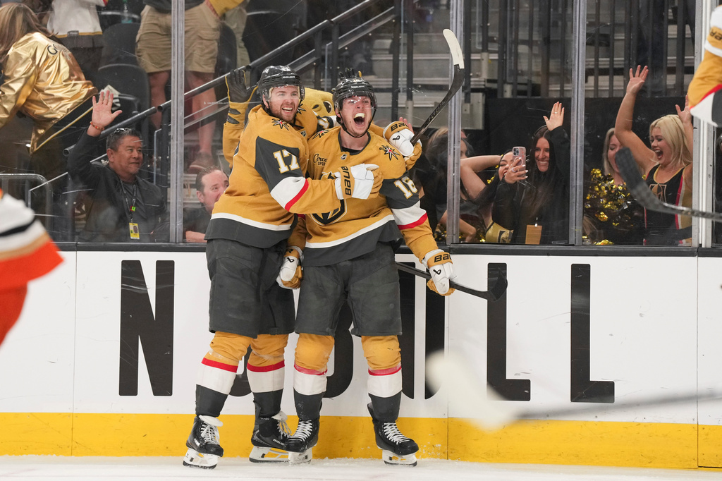 Vegas Golden Knights right wing Pavel Dorofeyev (16) celebrates his game-winning goal with defenseman Ben Hutton (17) during overtime of Game 5 of a second-round NHL hockey Stanley Cup playoff series against the Anaheim Ducks Tuesday, May 12, 2026, in Las Vegas. (AP Photo/Candice Ward)