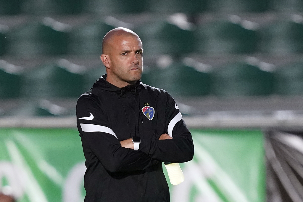 FILE - North Carolina Courage interim coach Sean Nahas waits for the team's NWSL soccer match against Racing Louisville FC in Cary, N.C., Oct. 6, 2021. (AP Photo/Gerry Broome, file)