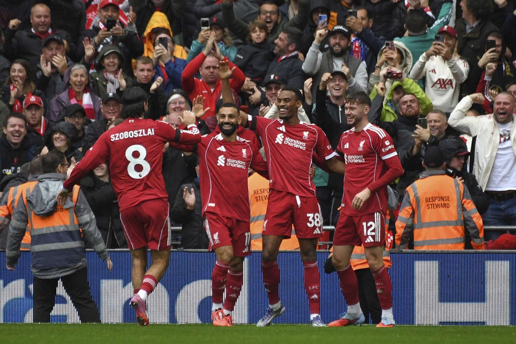 Liverpool's Ryan Gravenberch, second right, celebrates with teammates after scoring his side's opening goal during the English Premier League soccer match between Liverpool and Everton at Anfield stadium in Liverpool, England, Saturday, Sept. 20, 2025. (AP Photo/Rui Vieira)