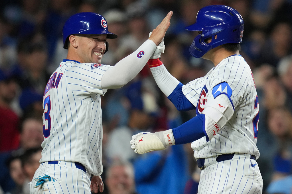 Chicago Cubs' Seiya Suzuki (27), right, celebrates with designated hitter Alex Bregman (3) after hitting a two-run home run during the seventh inning of a baseball game against the Philadelphia Phillies, Tuesday, April 21, 2026, in Chicago. (AP Photo/Erin Hooley)