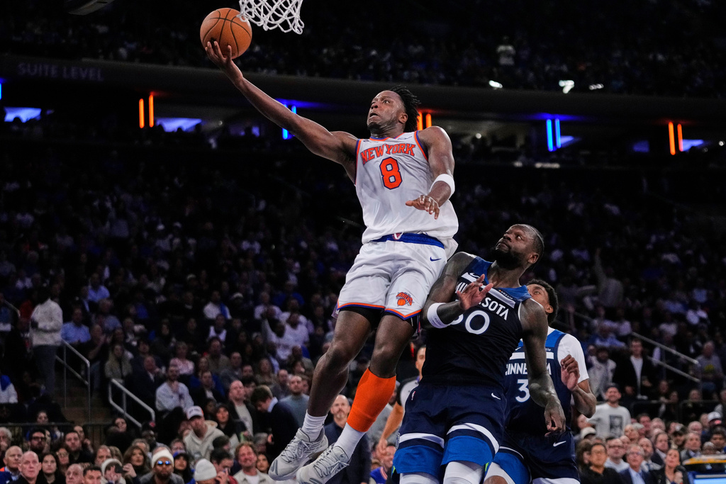 New York Knicks' Og Anunoby (8) drives past Minnesota Timberwolves' Julius Randle (30) during the second half of an NBA basketball game Wednesday, Nov. 5, 2025, at Madison Square Garden in New York. (AP Photo/Frank Franklin II)