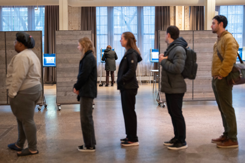 Voters wait in line while others fill out their ballots at Machine Shop in Minneapolis, Minn. on Tuesday, Nov. 4, 2025. (Alex Kormann/Star Tribune via AP)