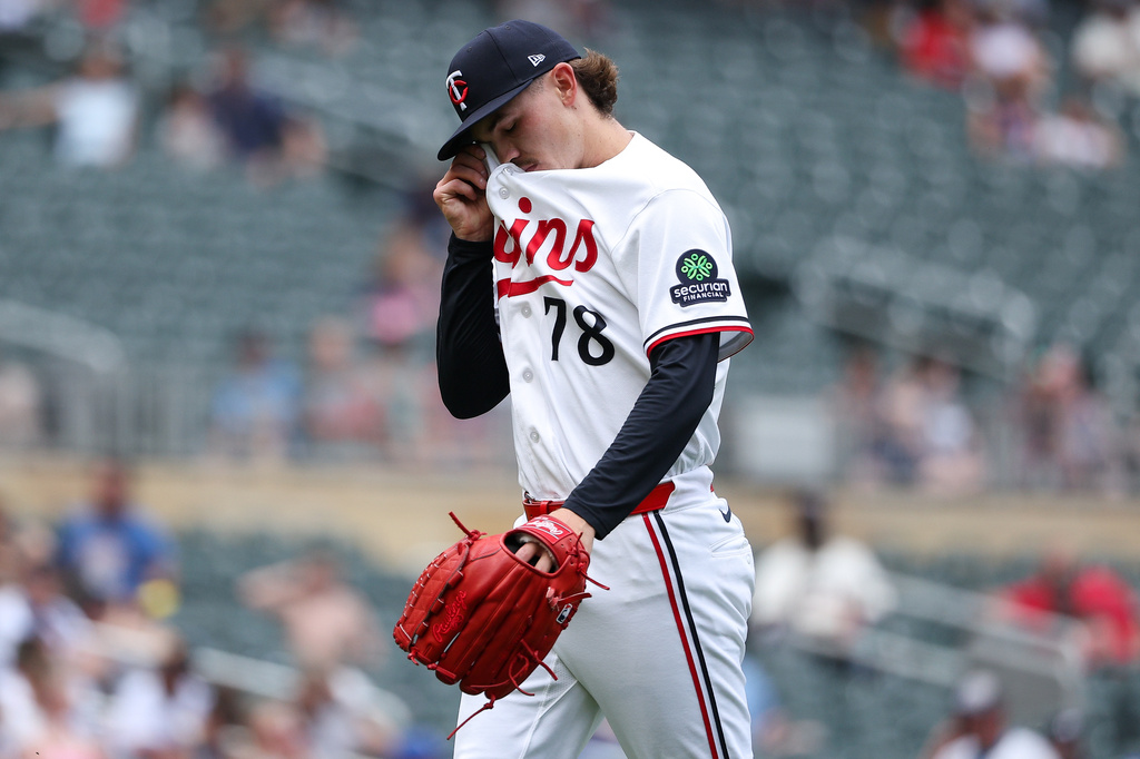 Minnesota Twins pitcher Andrew Morris wipes his face as he walks off the field during the fifth inning of a baseball game against the Kansas City Royals, Sunday, June 7, 2026, in Minneapolis. (AP Photo/Matt Krohn)