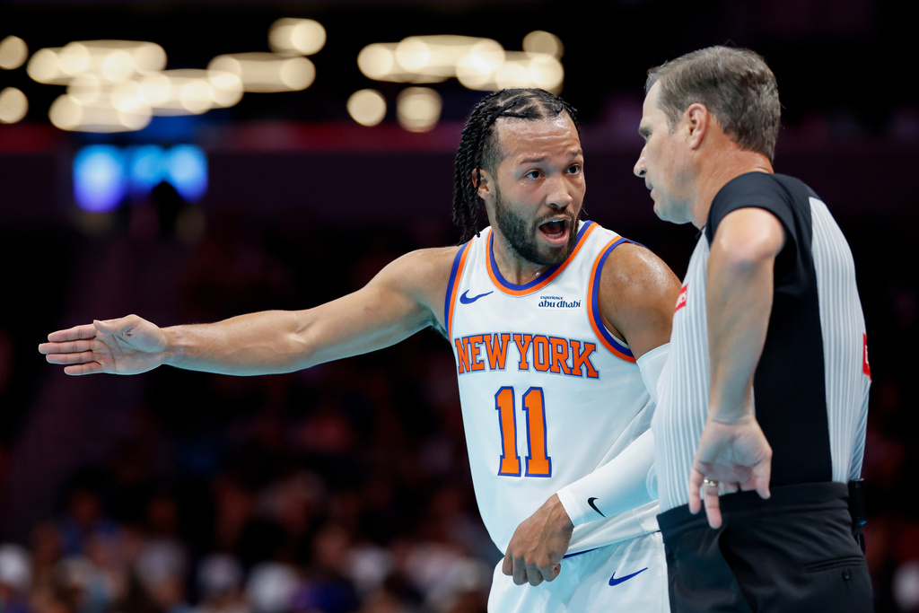 New York Knicks guard Jalen Brunson (11) talks to referee David Guthrie during the first half of an Emirates NBA Cup basketball game against the Charlotte Hornets in Charlotte, N.C., Wednesday, Nov. 26, 2025. (AP Photo/Nell Redmond)