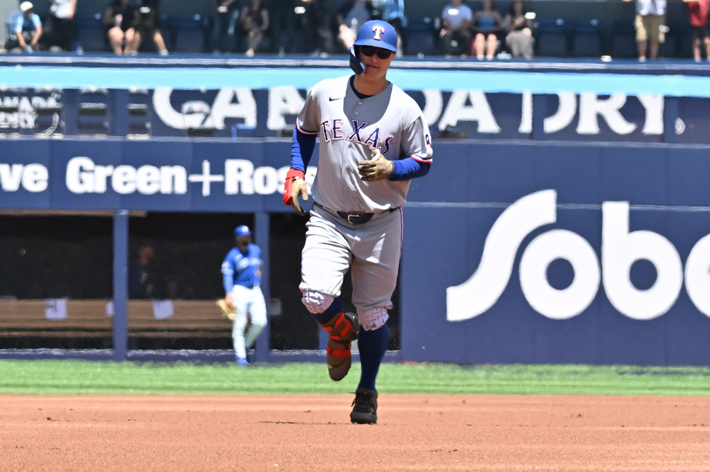 Texas Rangers designated hitter Joc Pederson runs the bases after hitting a solo home run against the Toronto Blue Jays during the first inning of a baseball game in Toronto, Sunday, June 28, 2026. (Jon Blacker/The Canadian Press via AP)