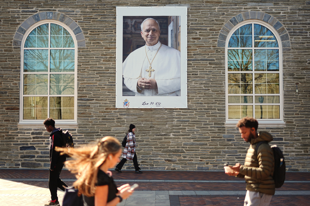 Students walk past an image of Pope Leo XIV at Villanova University in Villanova, Pa., Wednesday, Oct. 21, 2026. (AP Photo/Matt Rourke)
