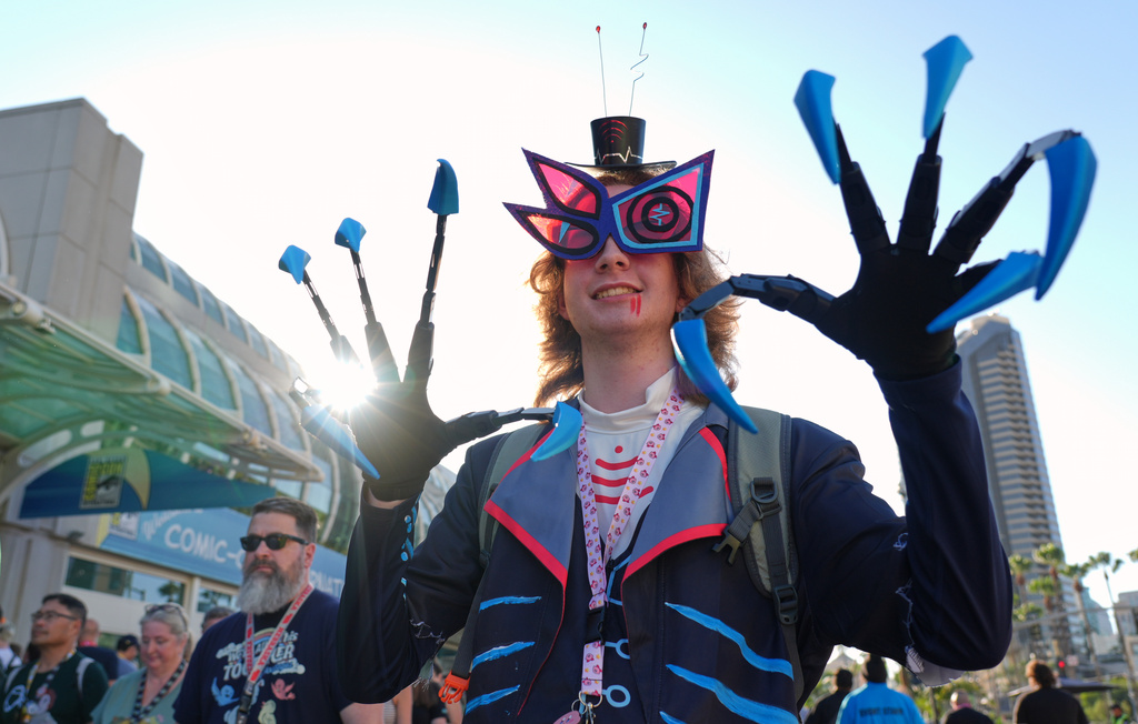 Zeb McCollum of Winston-Salem, N.C., dressed as the character Vox from the "Hazbin Hotel" streaming series, strikes a pose before preview night at Comic-Con International on Wednesday, July 22, 2026, in San Diego. (AP Photo/Chris Pizzello)