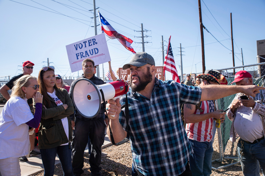 FILE - Republican supporters stand outside the Maricopa County Recorder's Office to protest what they allege is an unfair election in Phoenix on Nov. 12, 2022. (AP Photo/Alberto Mariani, File)
