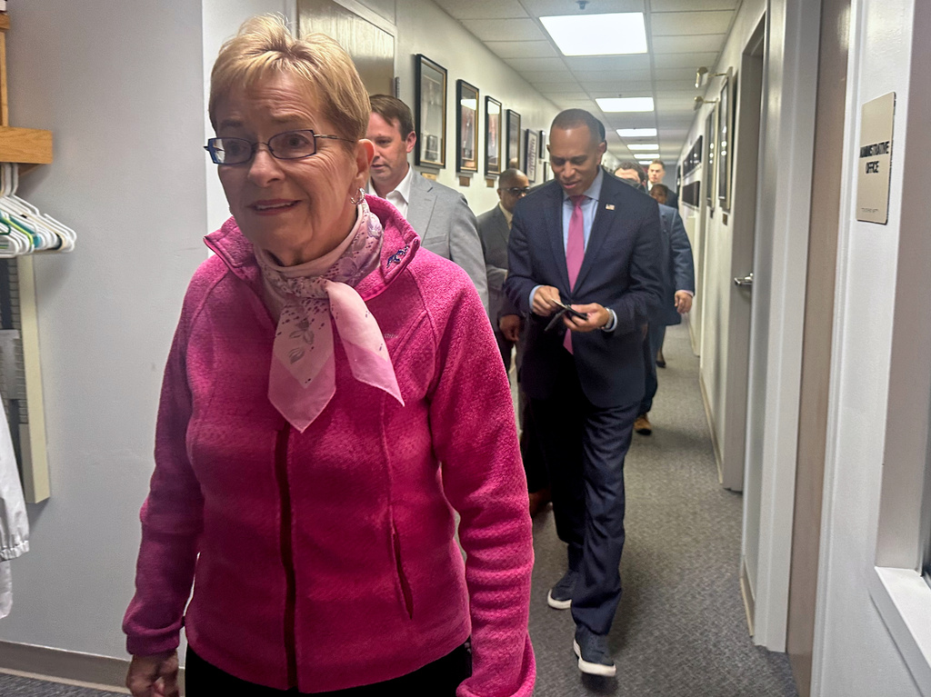 In this photo taken with a smart phone, Rep. Marcy Kaptur, left, and House Democratic Leader Hakeem Jeffries walk before a church services as they campaign for the midterm elections, Sunday, Oct. 18, 2026, in battleground Toledo, Ohio. (AP Photo/Lisa Mascaro)