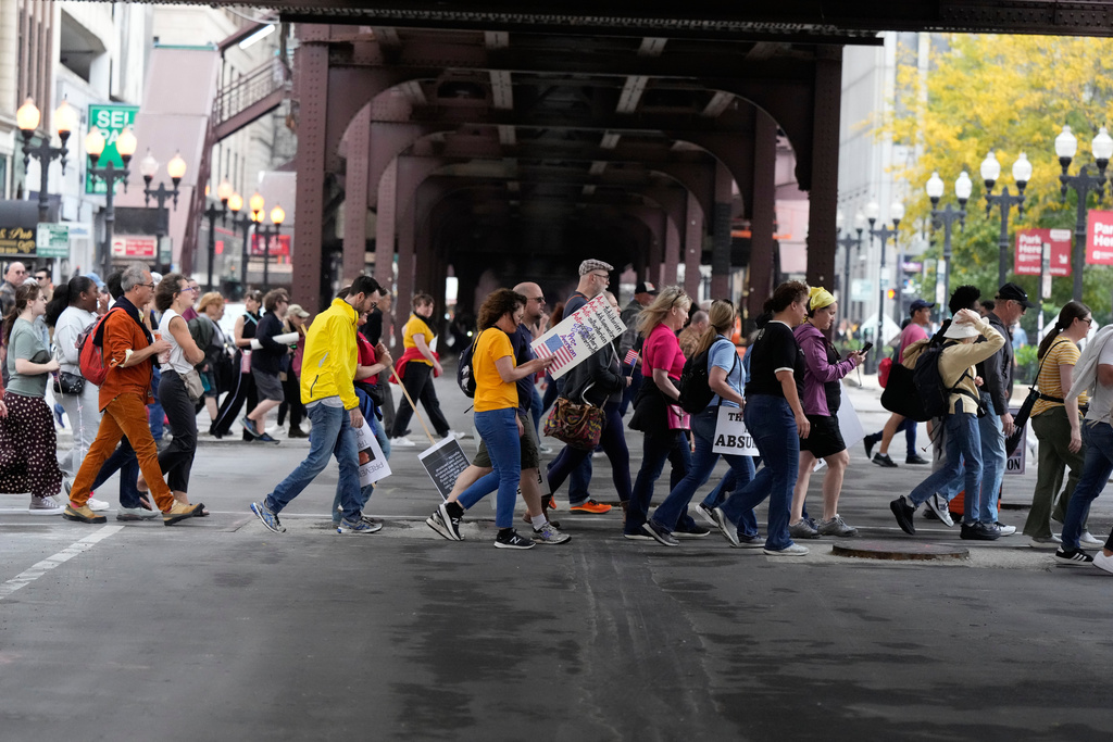 People walk to Grant Park before a "No Kings" protest Saturday, Oct. 18, 2025, in Chicago. (AP Photo/Nam Y. Huh)