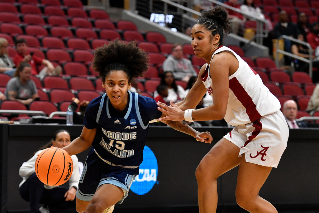 Rhode Island guard Sophia Vital (15) drives past Alabama guard Diana Collins (20) during the second half in the first round of the NCAA college basketball tournament, Saturday, March 21, 2026 in Louisville, Ky. (AP Photo/Timothy D. Easley)