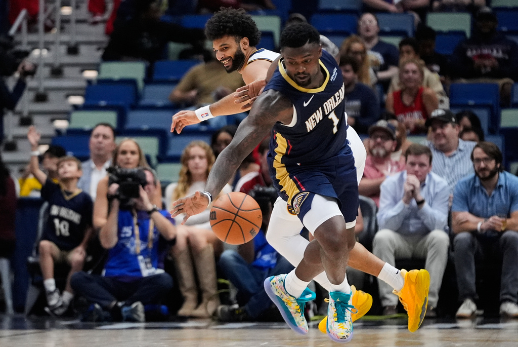 New Orleans Pelicans forward Zion Williamson (1) steals the ball from Denver Nuggets forward Spencer Jones in the first half of an NBA basketball game, Wednesday, Nov. 19, 2025, in New Orleans. (AP Photo/Gerald Herbert)
