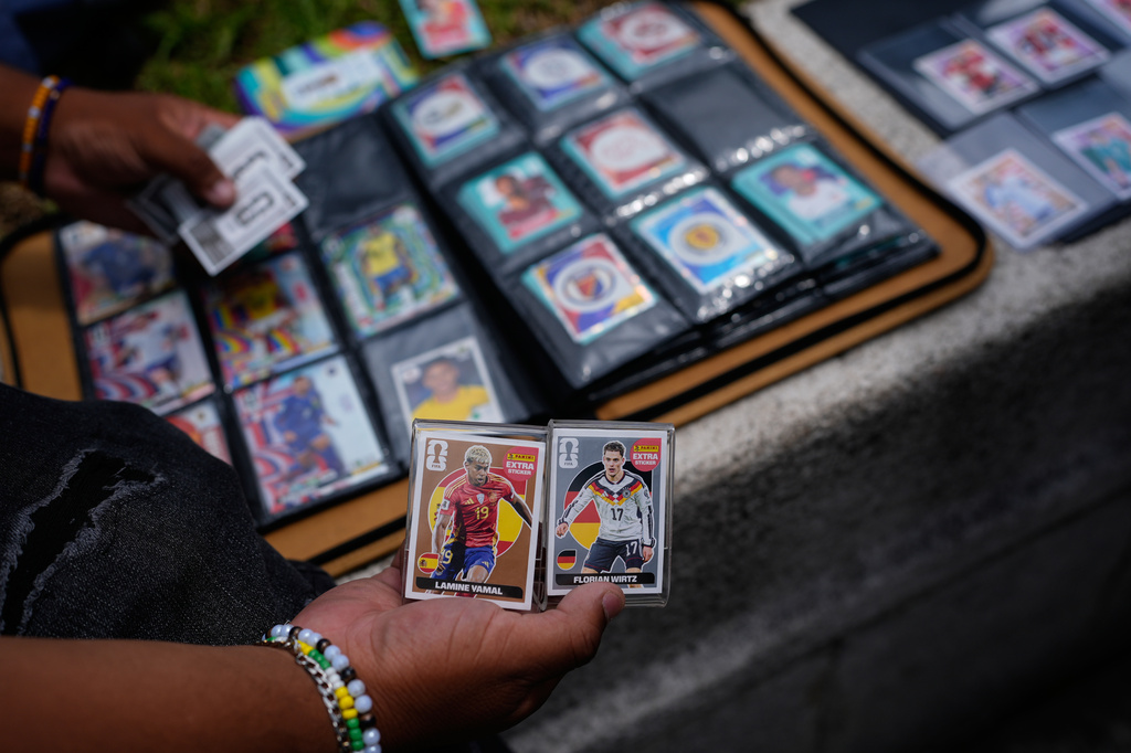 Youth exchange Panini World Cup stickers in Mexico City, Tuesday, June 16, 2026. (AP Photo/Marco Ugarte)