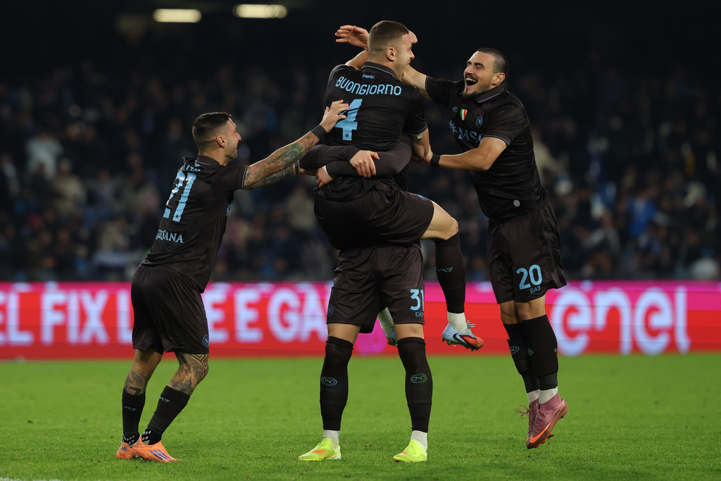 Napoli's Alessandro Buongiorno, top, celebrates after scoring during the round of sixteen Italian Cup soccer match between Napoli and Cagliari in Naples, Italy, Wednesday, Dec. 3, 2025. (Alessandro Garofalo/LaPresse via AP)