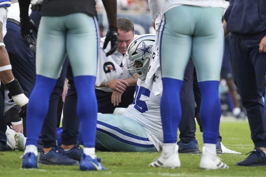 Dallas Cowboys defensive tackle Kenny Clark, center on ground, is attended to by team medical staff after suffering an unknown injury in the second half of an NFL football game against the Chicago Bears Sunday, Sept. 21, 2025, in Chicago. (AP Photo/Nam Y. Huh)