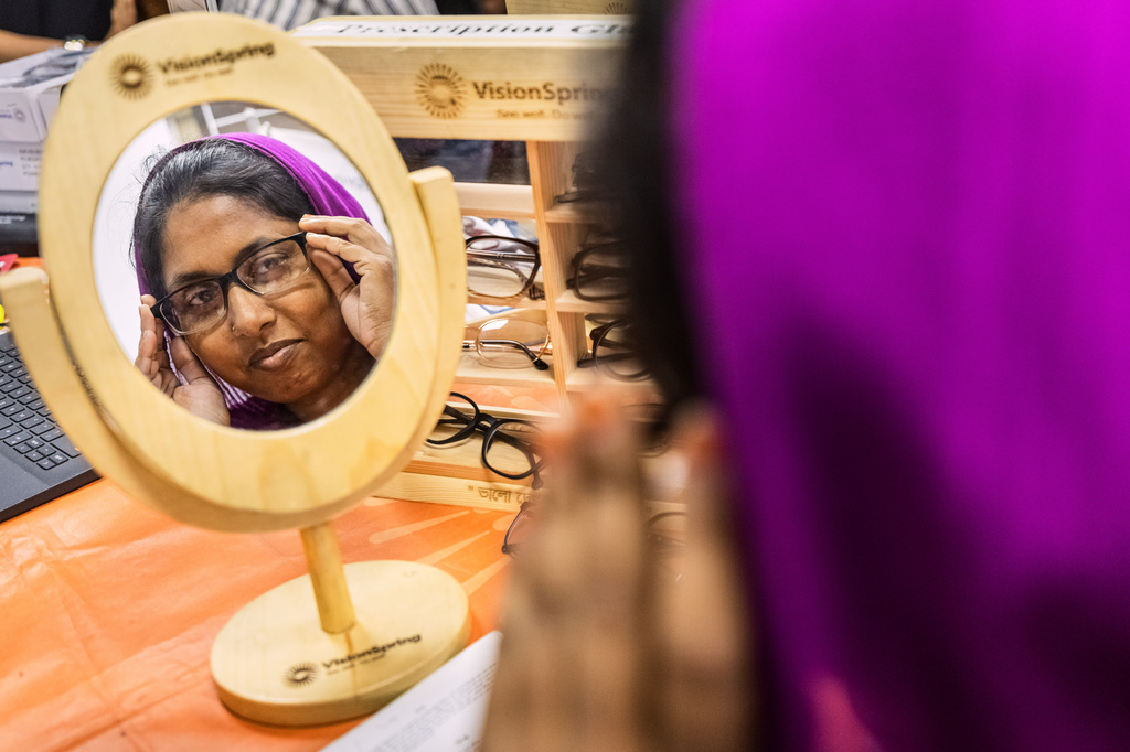 A worker tries on her prescription eyeglasses at a garment factory in Gazipur, on the outskirts of Dhaka, Bangladesh, June 30, 2026. (AP Photo/Rajib Dhar)