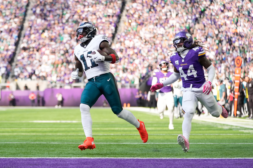 Philadelphia Eagles wide receiver A.J. Brown (11) scores a touchdown past Minnesota Vikings safety Joshua Metellus (44) during the first half of an NFL football game Sunday, Oct. 19, 2025, in Minneapolis. (AP Photo/Abbie Parr)