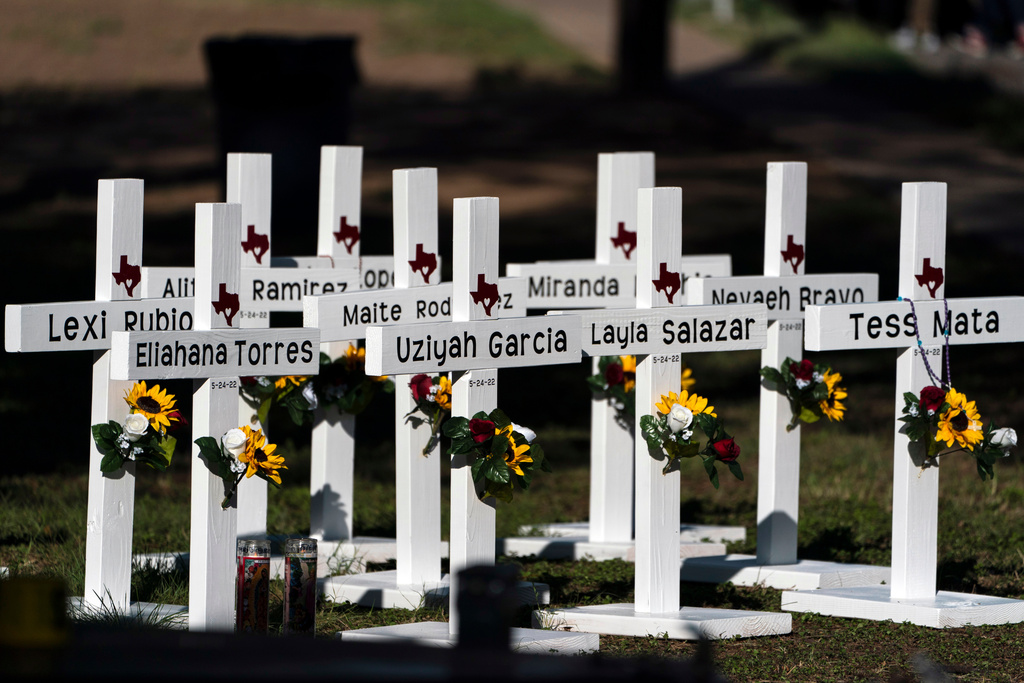 FILE - Crosses with the names of shooting victims are placed outside Robb Elementary School in Uvalde, Texas, May 26, 2022. (AP Photo/Jae C. Hong, File)