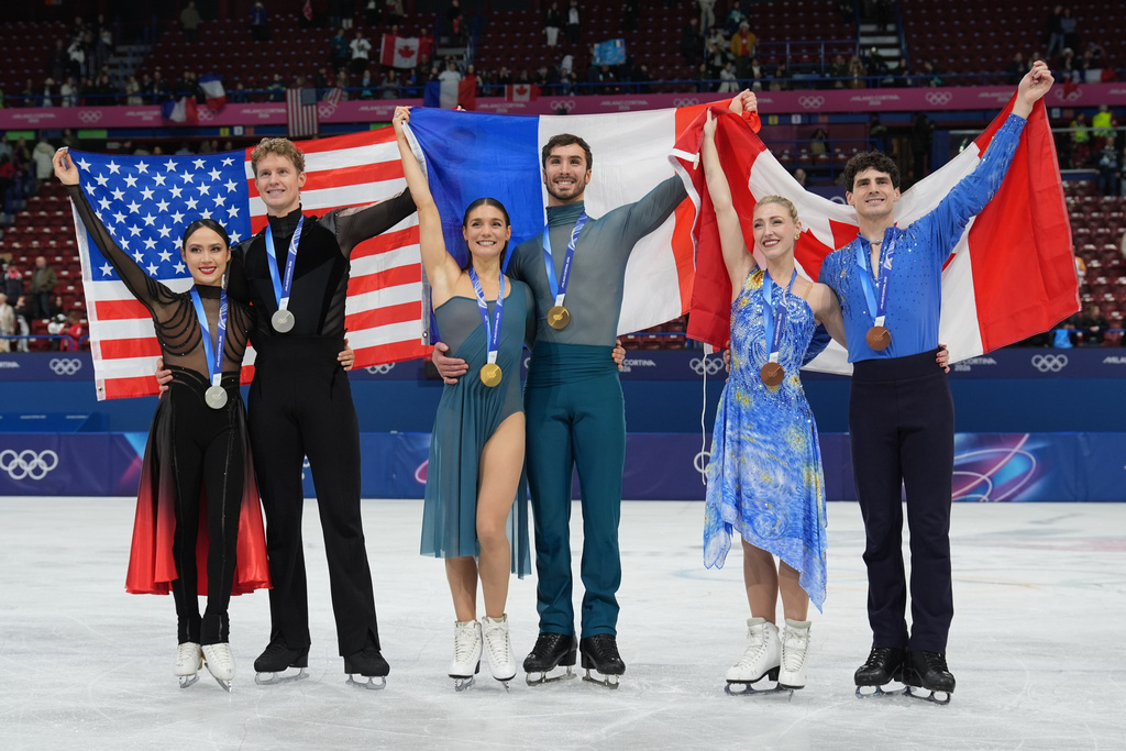 From left to right, silver medalists Madison Chock and Evan Bates of the United States, gold medalists Laurence Fournier Beaudry and Guillaume Cizeron of France, and bronze medalists Piper Gilles and Paul Poirier of Canada, pose with their medals after the ice dancing free skate in figure skating at the 2026 Winter Olympics, in Milan, Italy, Wednesday, Feb. 11, 2026. (AP Photo/Stephanie Scarbrough)