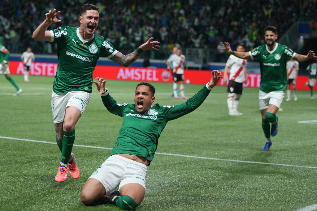 Vitor Roque of Brazil's Palmeiras, center, celebrates with teammates after scoring his side's opening goal against Argentina's River Plate during a World Cup 2026 qualifying soccer match at Neo Quimica Arena in Sao Paulo, Tuesday, June 10, 2025. (AP Photo/Andre Penner)