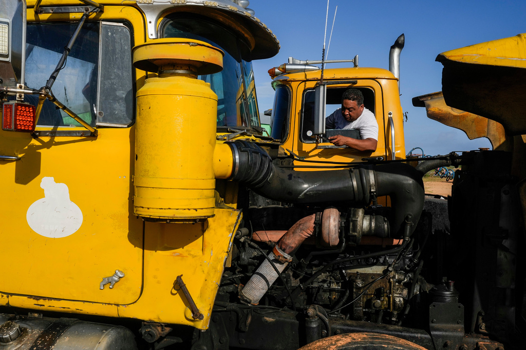 Truck driver Francisco Rodriguez waits to load salt at the Salinas de Cumaraguas salt flats on the Paraguana Peninsula, Venezuela, Thursday, Jan. 15, 2026. (AP Photo/Matias Delacroix)