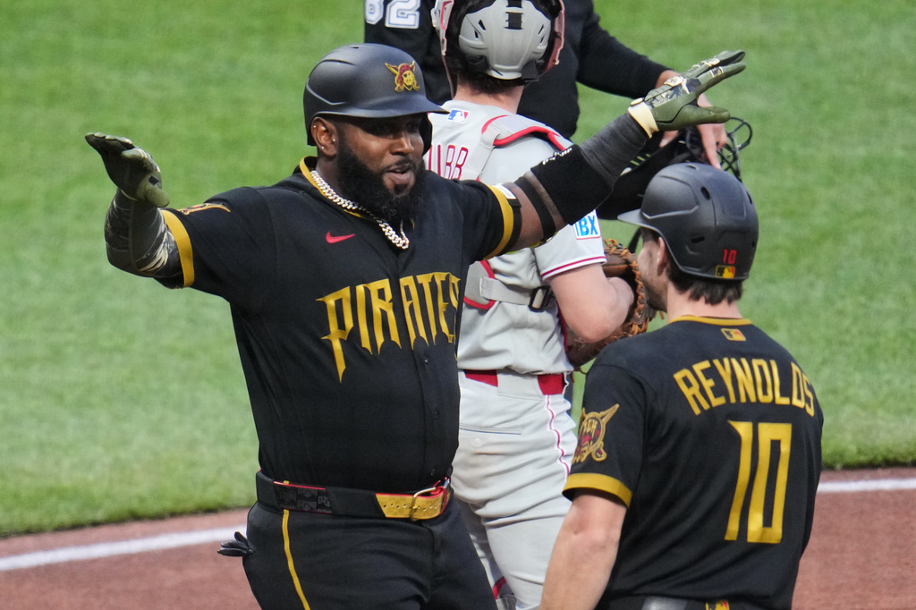 Pittsburgh Pirates' Marcell Ozuna, left, celebrates with Bryan Reynolds (10) after hitting a two-run home run off Philadelphia Phillies pitcher Aaron Nola during the third inning of a baseball game in Pittsburgh, Friday, May 15, 2026. (AP Photo/Gene J. Puskar)