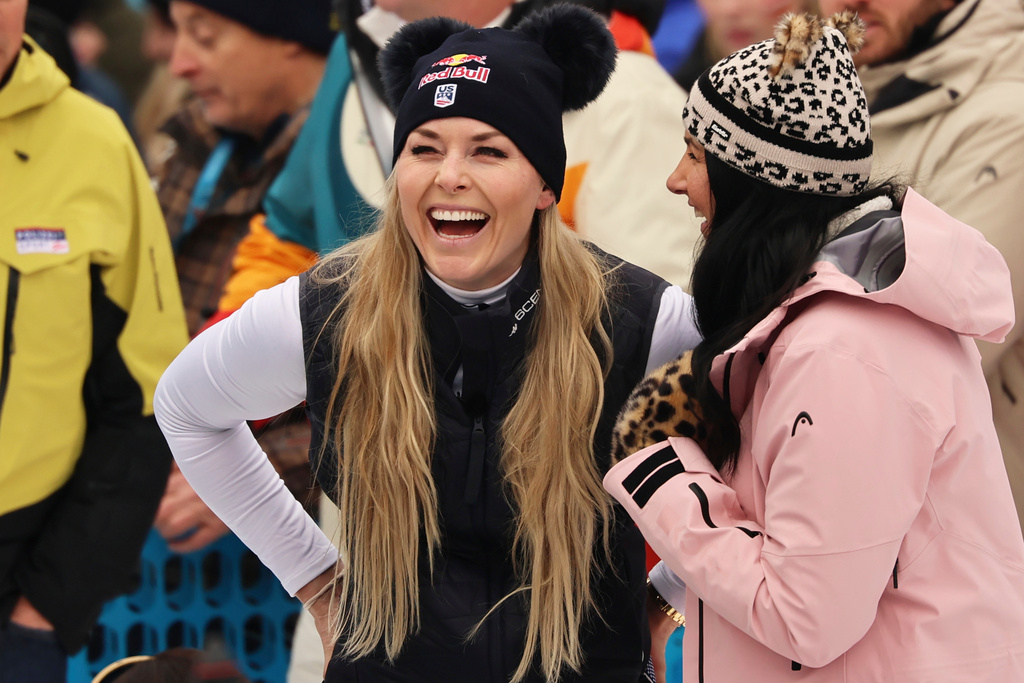 United States' Lindsey Vonn, center, smiles at the finish area of an alpine ski, women's World Cup downhill, in Tarvisio, Italy, Saturday, Jan. 17, 2026. (AP Photo/Marco Trovati)