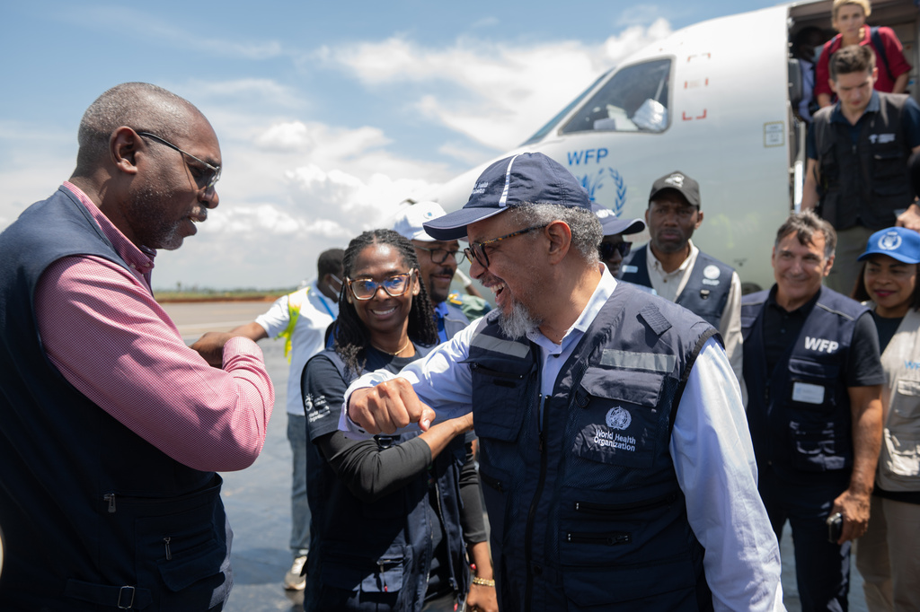 Director General of the World Health Organisation (WHO) Tedros Adhanom Ghebreyesus, right, is welcomed at Bunia airport in Bunia, Congo, Saturday, May 30, 2026. (AP Photo/Moses Sawasawa)