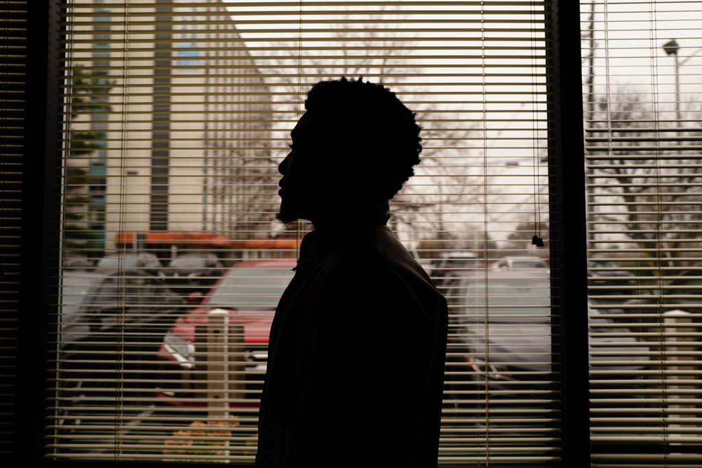 Louis, a Congolese refugee, stands for an anonymous portrait at the International Rescue Committee (IRC) office, Wednesday, Nov. 19, 2025, in Louisville, Ky. (AP Photo/Jon Cherry)
