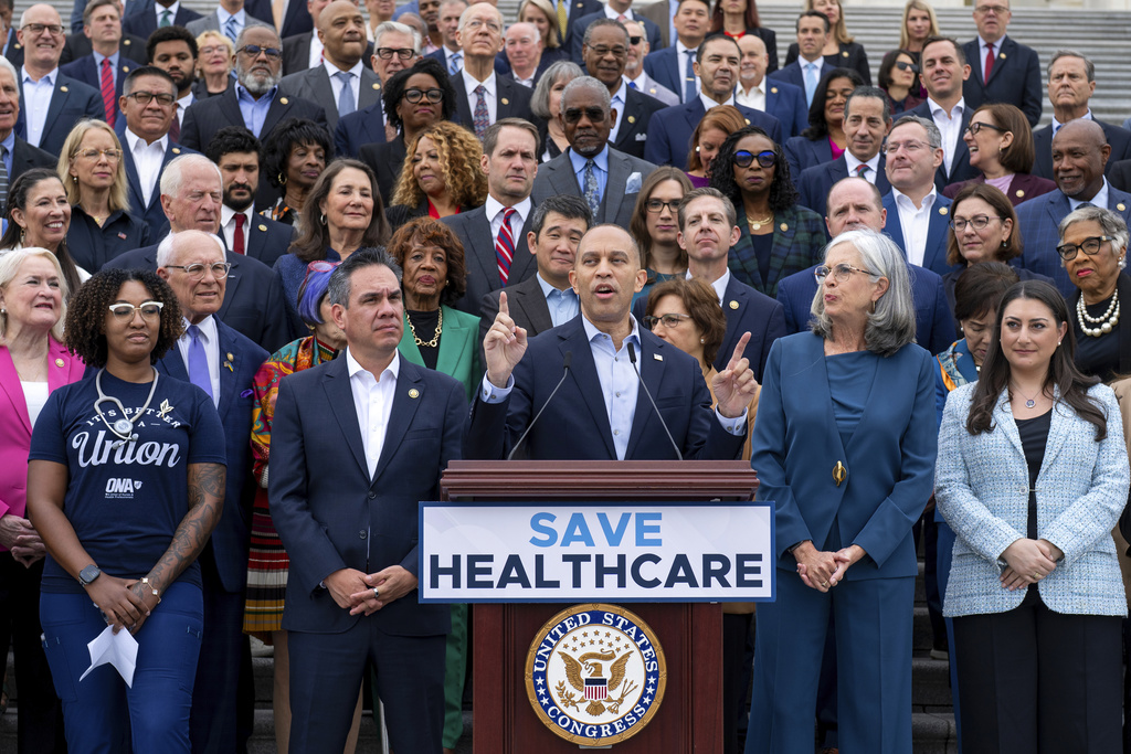 House Minority Leader Hakeem Jeffries, D-N.Y., center, flanked by Rep. Pete Aguilar, D-Calif., left, and Rep. Katherine Clark, D-Mass., arrives to speak on the steps of the Capitol to insist that Republicans include an extension of expiring health care benefits as part of a government funding compromise, in Washington, Tuesday, Sept. 30, 2025. (AP Photo/J. Scott Applewhite)