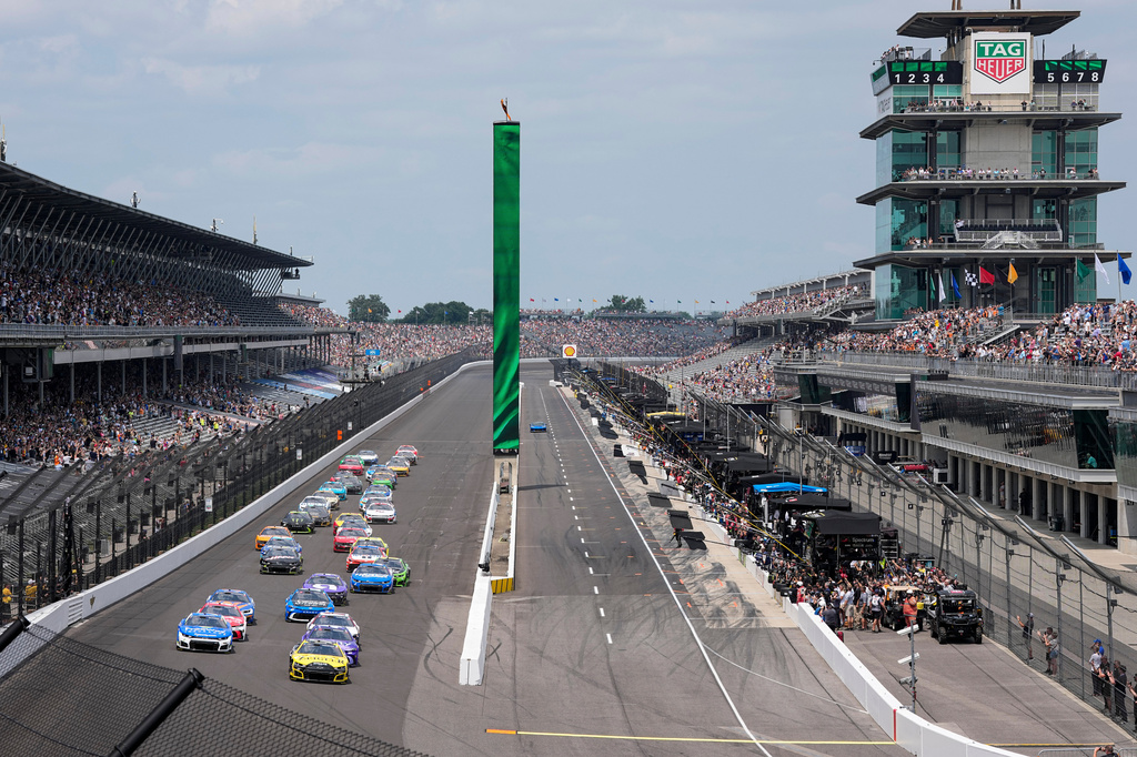 Carson Hocevar (77) leads the field on the start of a NASCAR Cup Series auto race at Indianapolis Motor Speedway in Indianapolis, Sunday, July 26, 2026. (AP Photo/Michael Conroy)